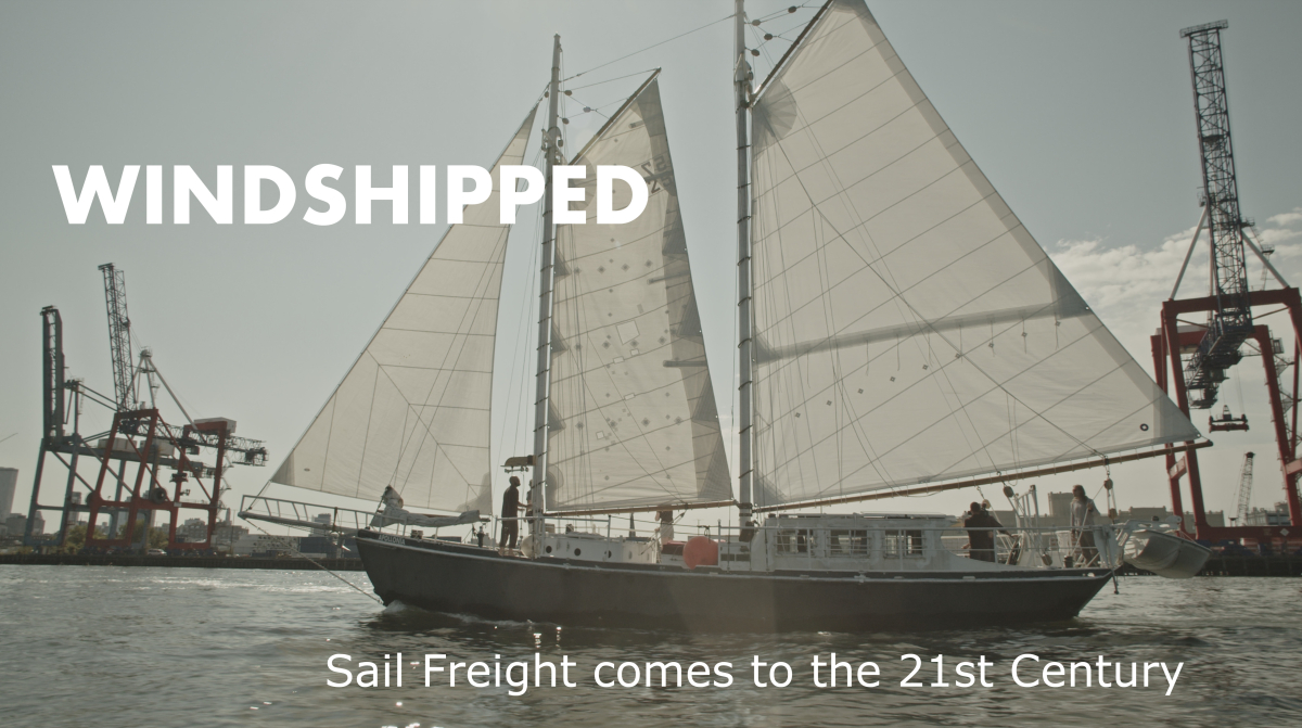 Apollonia ship with industrial freight cranes and text Windshipped: Sail Freight comes to the 21st Century"